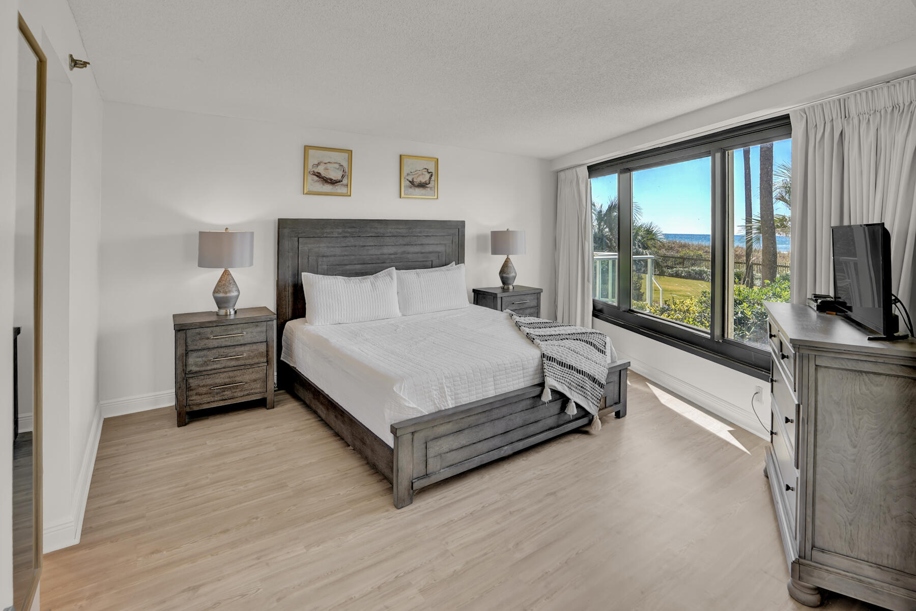 4202 Beachside 2, Unit 202 Miramar Beach, FL 32550 - Photo 10 of 45 a spacious bedroom with a bed and a flat tv screen on dresser