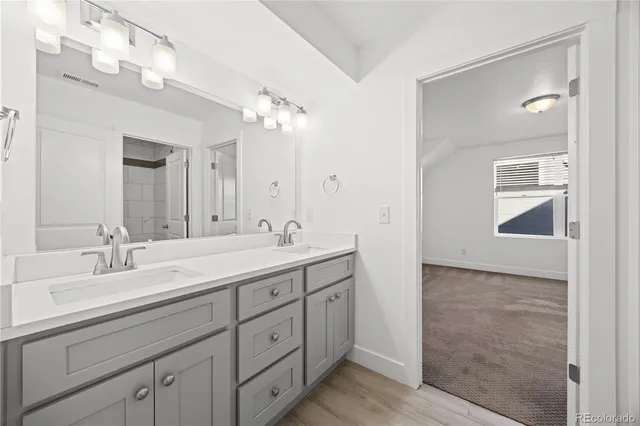 a spacious bathroom with a double vanity sink mirror and