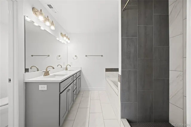 a bathroom with a sink a mirror and a shower