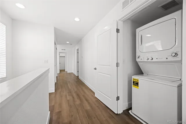 a view of hallway with wooden floor