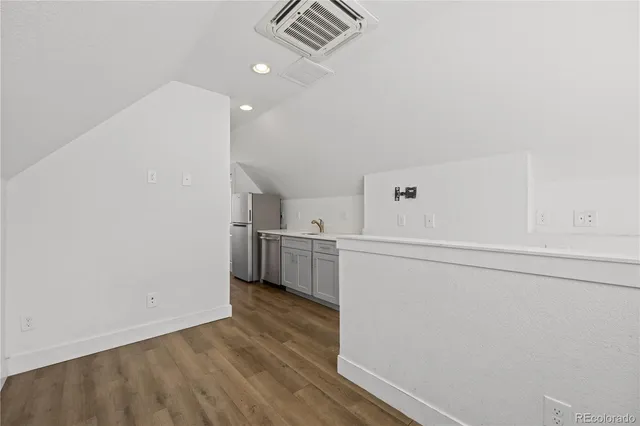 a view of a kitchen with refrigerator and microwave