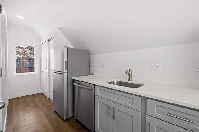 a kitchen with a sink and refrigerator