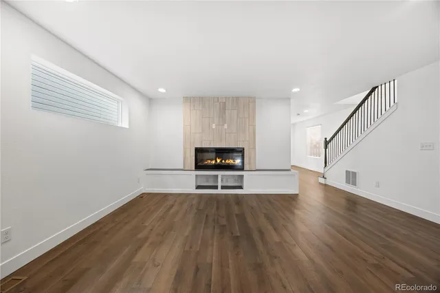a living room with wooden floors and a ceiling fan