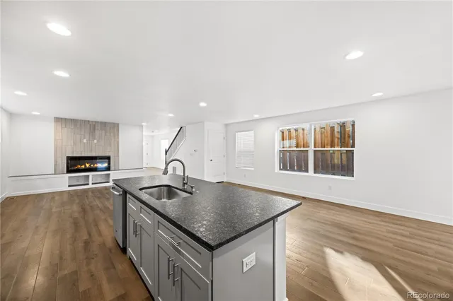 a kitchen with kitchen island a sink stove and microwave