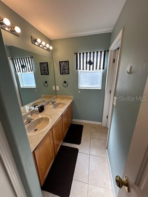 1449 Kaffir Lily Court Trinity, FL 34655 - Photo 30 of 53 a bathroom with a sink a toilet and a mirror
