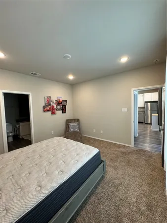 a living room with a bed and a flat screen tv