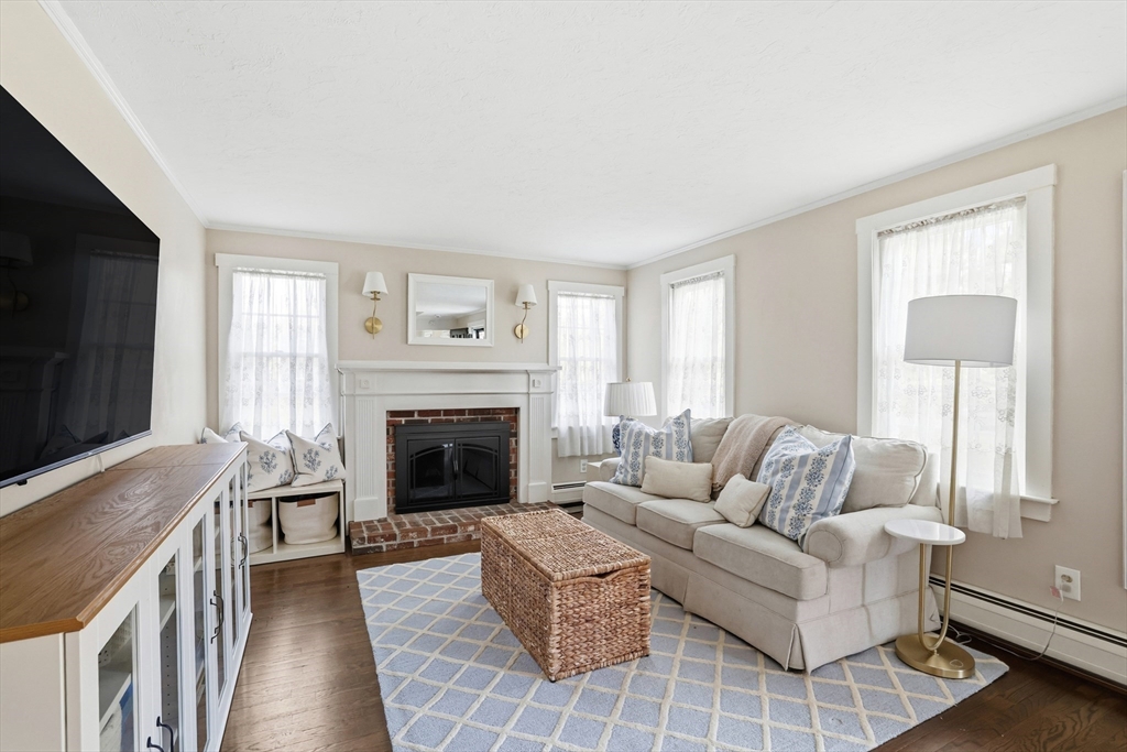 73 Shingle Mill Lane Hanover, MA 02339 - Photo 12 of 23 a living room with furniture a flat screen tv and a fireplace
