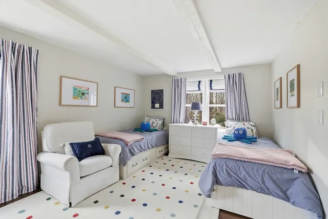 a bedroom with a large bed couch and a window