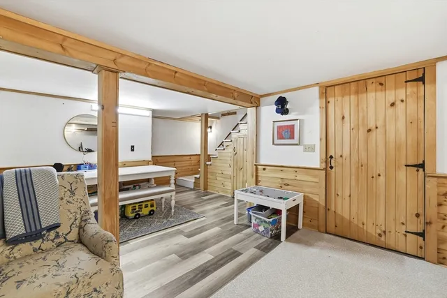 a living room with furniture a flat screen tv and a window