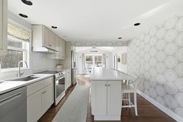 a kitchen with stainless steel appliances a sink and cabinets