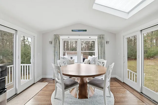 a dining room with furniture window and wooden floor