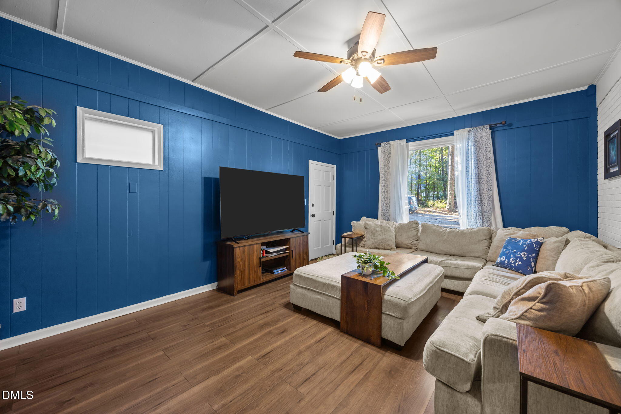 9433 Ferrell Road Zebulon, NC 27597 - Photo 11 of 38 a living room with furniture and a flat screen tv