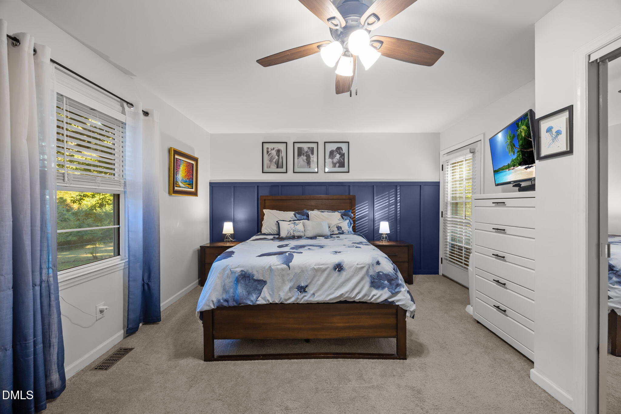 9433 Ferrell Road Zebulon, NC 27597 - Photo 16 of 38 a bedroom with a bed and a chandelier