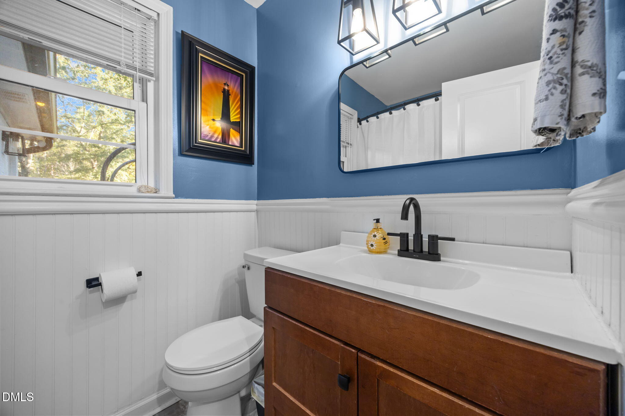 9433 Ferrell Road Zebulon, NC 27597 - Photo 20 of 38 a bathroom with a toilet a sink and mirror