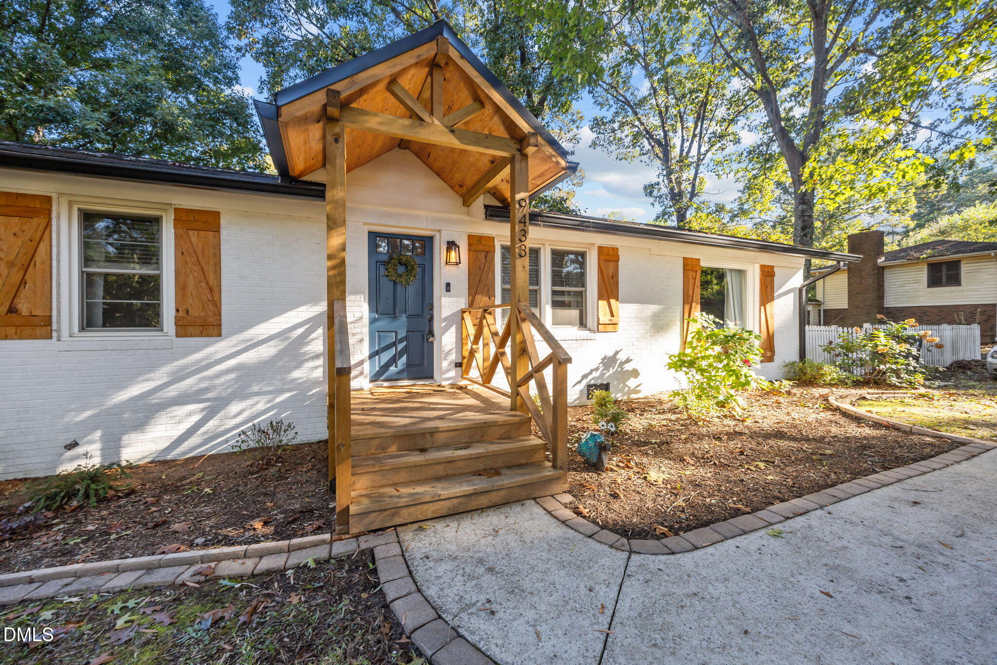 9433 Ferrell Road Zebulon, NC 27597 - Photo 2 of 38 a front view of a house with garden