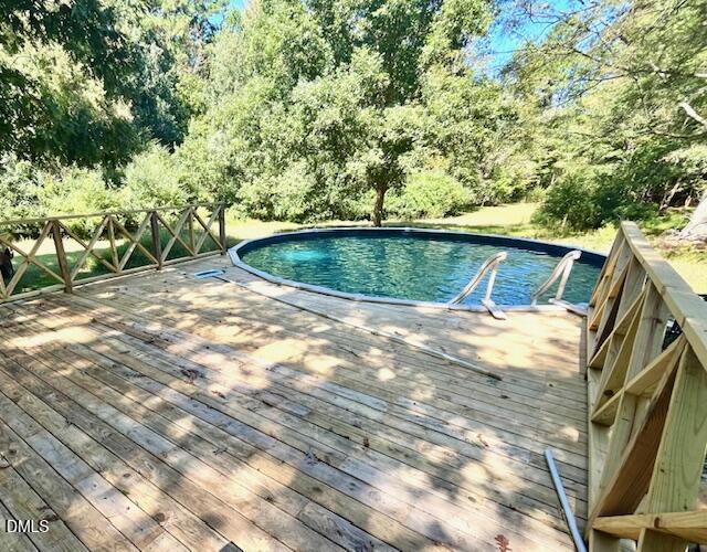 9433 Ferrell Road Zebulon, NC 27597 - Photo 26 of 38 a view of a swimming pool with a yard
