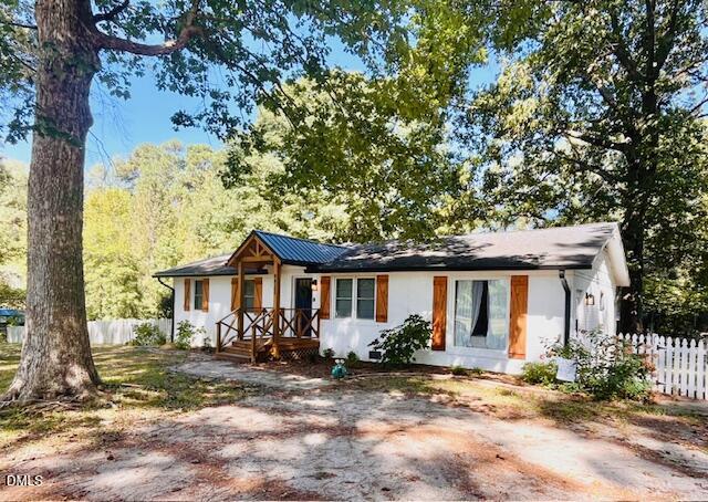 9433 Ferrell Road Zebulon, NC 27597 - Photo 30 of 38 a view of a yard in front of a house with large tree