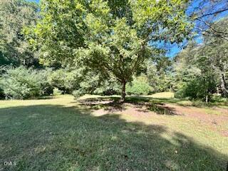 9433 Ferrell Road Zebulon, NC 27597 - Photo 34 of 38 a view of a field with trees in the background