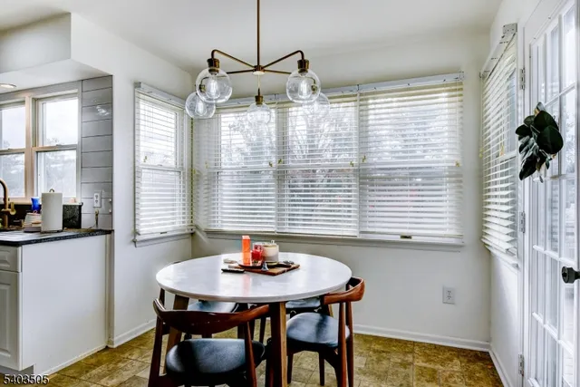 a view of a dining room with furniture and window