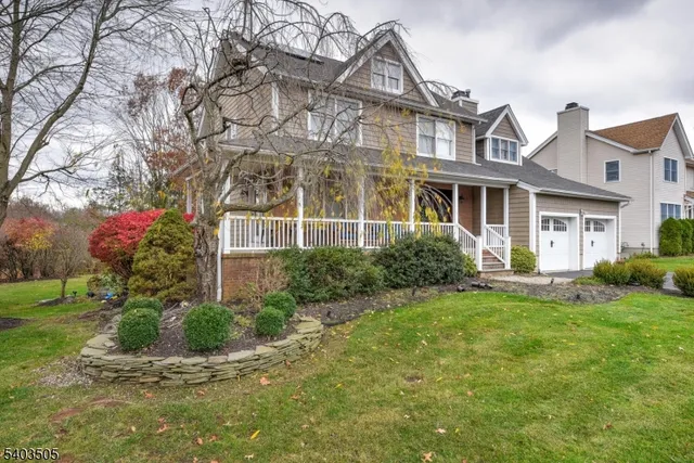 a front view of a house with a yard and potted plants