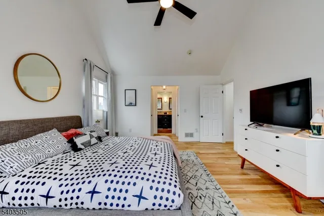 a bedroom with a bed and flat screen tv
