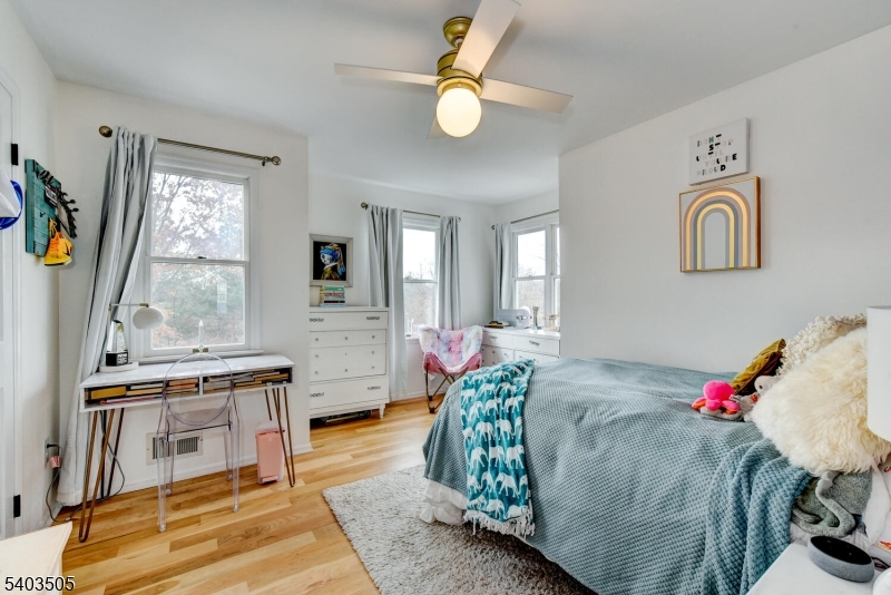 3 Fine Road Hillsborough, NJ 08844 - Photo 32 of 47 a bedroom with a bed and a chandelier