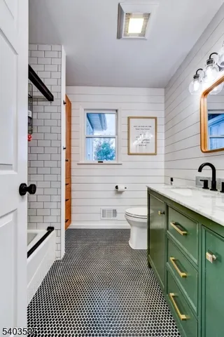 a bathroom with a double vanity sink a toilet and a mirror