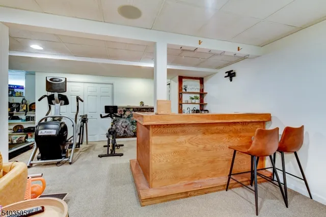 a room with gym equipment and a view of living room