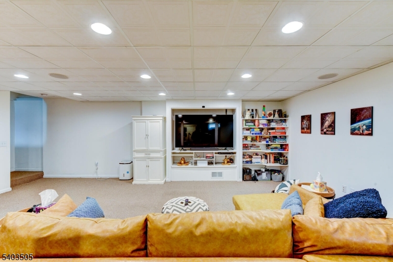 3 Fine Road Hillsborough, NJ 08844 - Photo 39 of 47 a living room with furniture and a flat screen tv