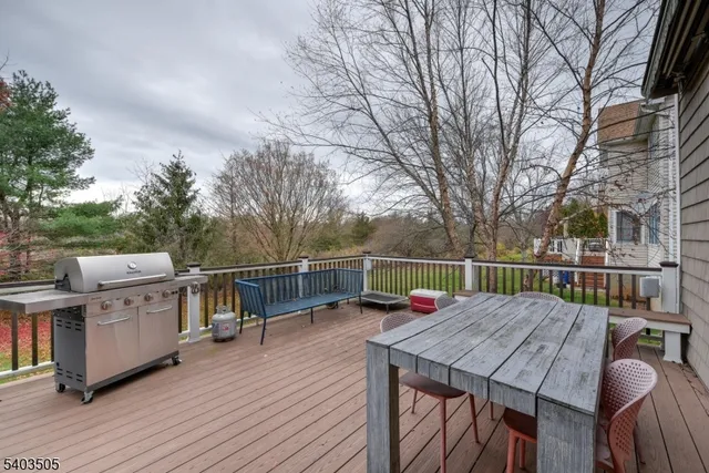 a view of house with deck and outdoor seating
