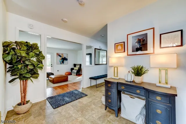 a living room with furniture potted plant and a lamp