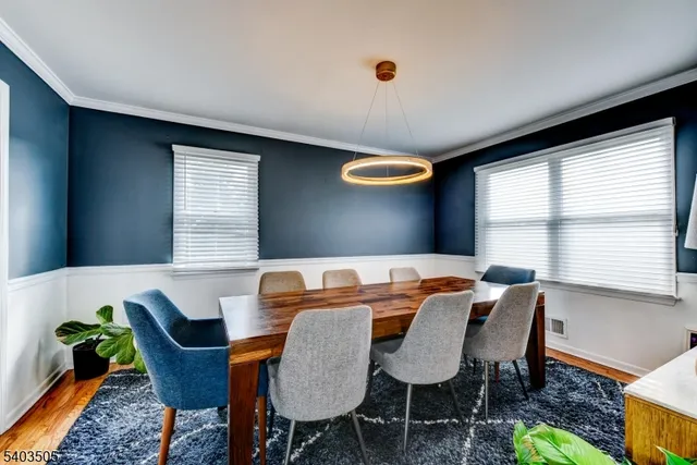 a view of a dining room with furniture and a window