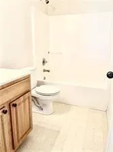 a bathroom with a toilet a sink and a mirror