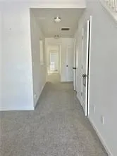 a view of a hallway with wooden shelves