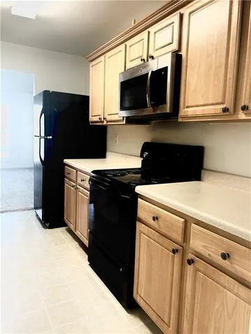a kitchen with a refrigerator stove and microwave