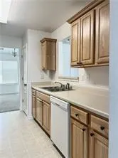 a kitchen with granite countertop a sink stainless steel appliances and cabinets