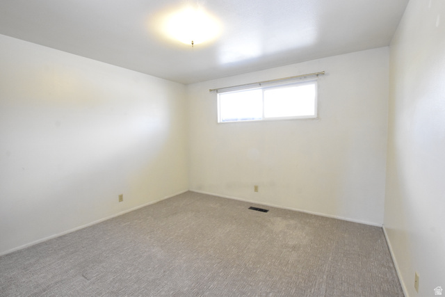 290 West 600 North Logan, UT 84321 - Photo 34 of 45 Neutral-toned carpeting paired with light-colored walls and a dual-pane window
