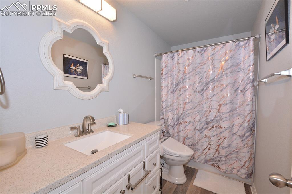 6967 Stetson Ranch Point, Unit 105 Colorado Springs, CO 80922 - Photo 20 of 37 a bathroom with a sink a toilet and a mirror