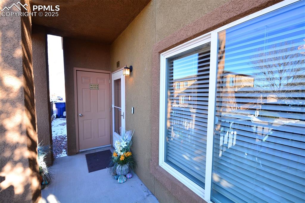 6967 Stetson Ranch Point, Unit 105 Colorado Springs, CO 80922 - Photo 2 of 37 a view of livingroom with hardwood floor and an outdoor space