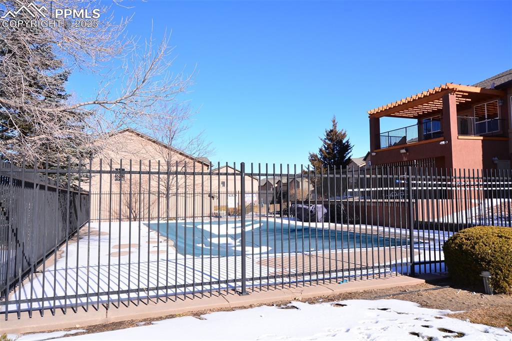 6967 Stetson Ranch Point, Unit 105 Colorado Springs, CO 80922 - Photo 24 of 37 a view of a black gate