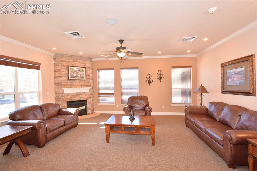 6967 Stetson Ranch Point, Unit 105 Colorado Springs, CO 80922 - Photo 25 of 37 a living room with furniture and a fireplace