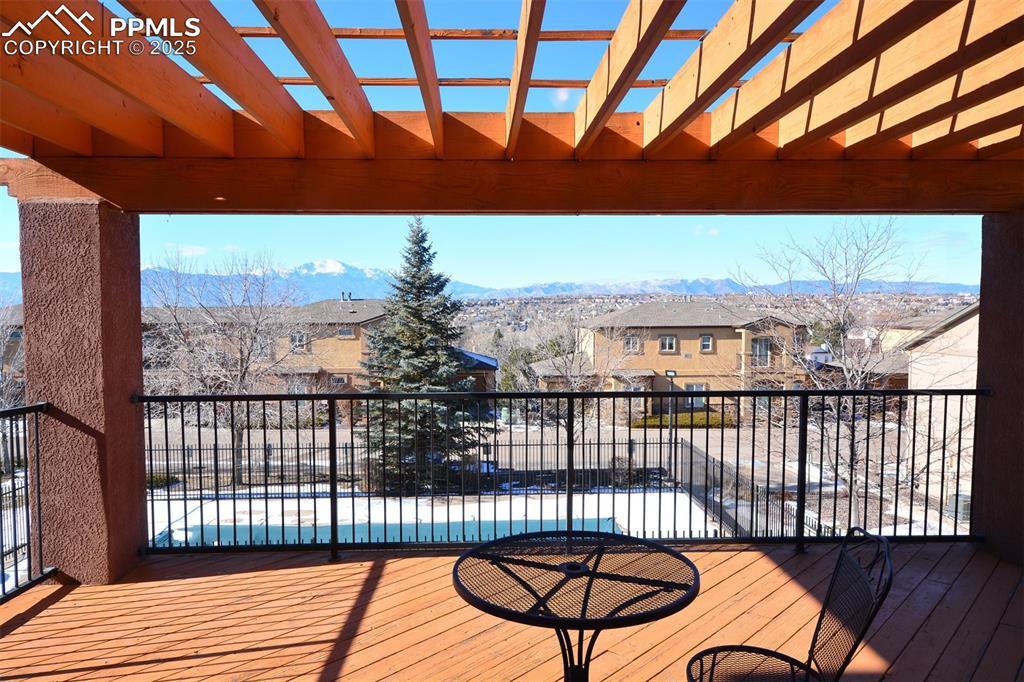 6967 Stetson Ranch Point, Unit 105 Colorado Springs, CO 80922 - Photo 28 of 37 a view of a balcony with wooden floor