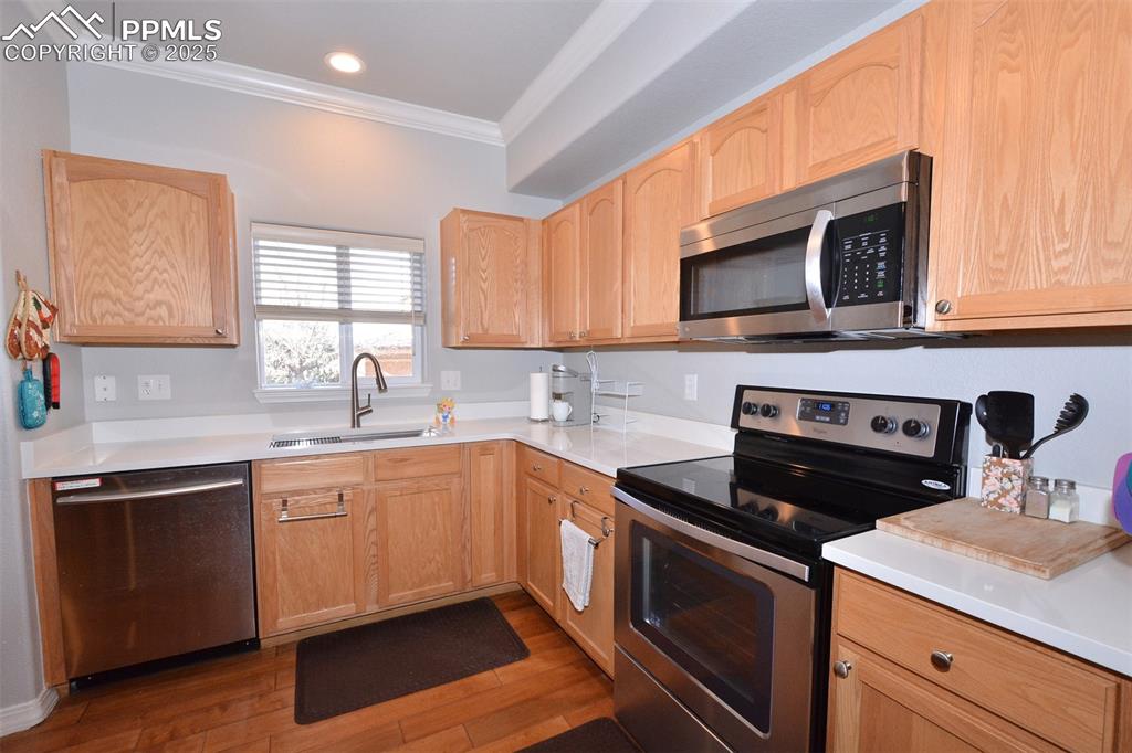 6967 Stetson Ranch Point, Unit 105 Colorado Springs, CO 80922 - Photo 7 of 37 a kitchen with a sink stove and microwave