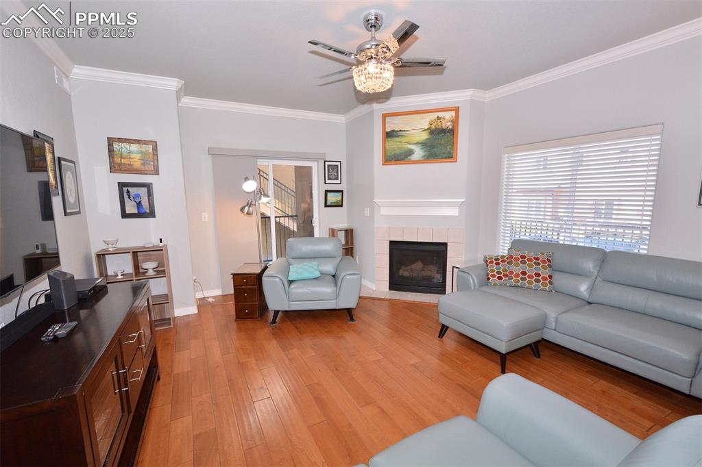 6967 Stetson Ranch Point, Unit 105 Colorado Springs, CO 80922 - Photo 10 of 37 a living room with furniture and a fireplace