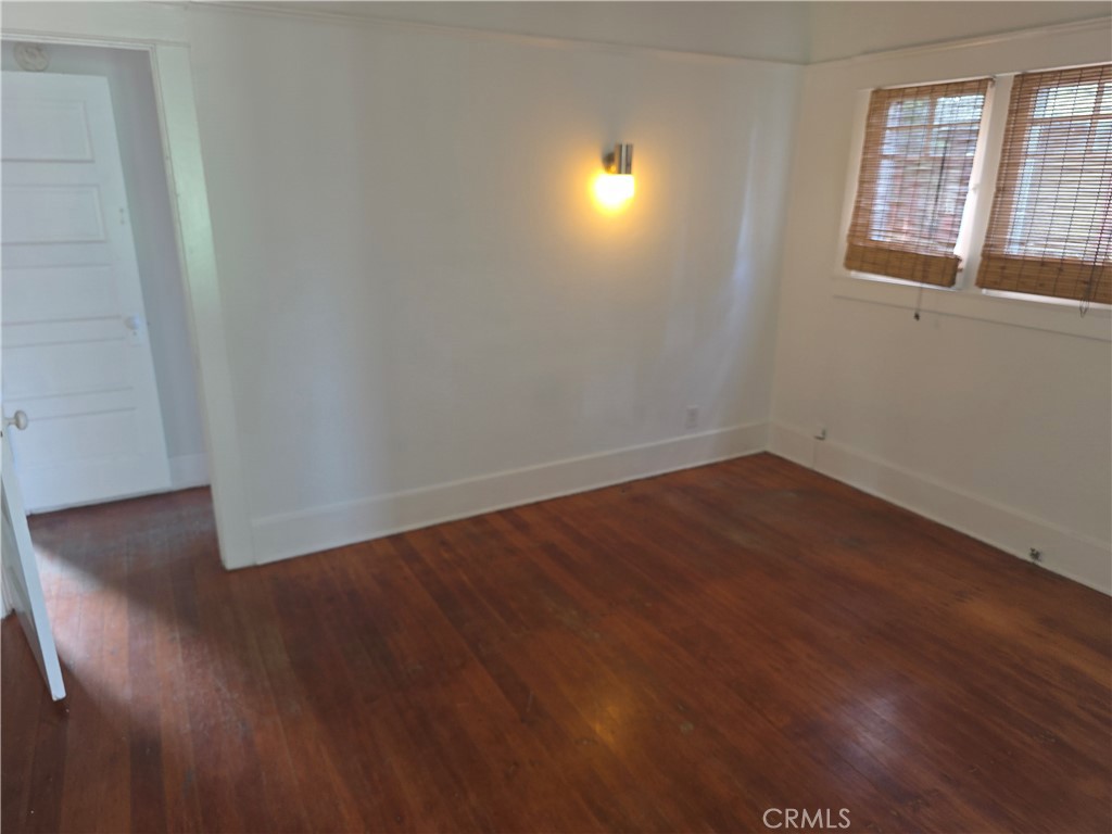 3992 Linwood Place Riverside, CA 92506 - Photo 8 of 9 an empty room with wooden floor and windows