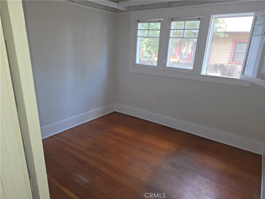 3992 Linwood Place Riverside, CA 92506 - Photo 9 of 9 an empty room with wooden floor and windows