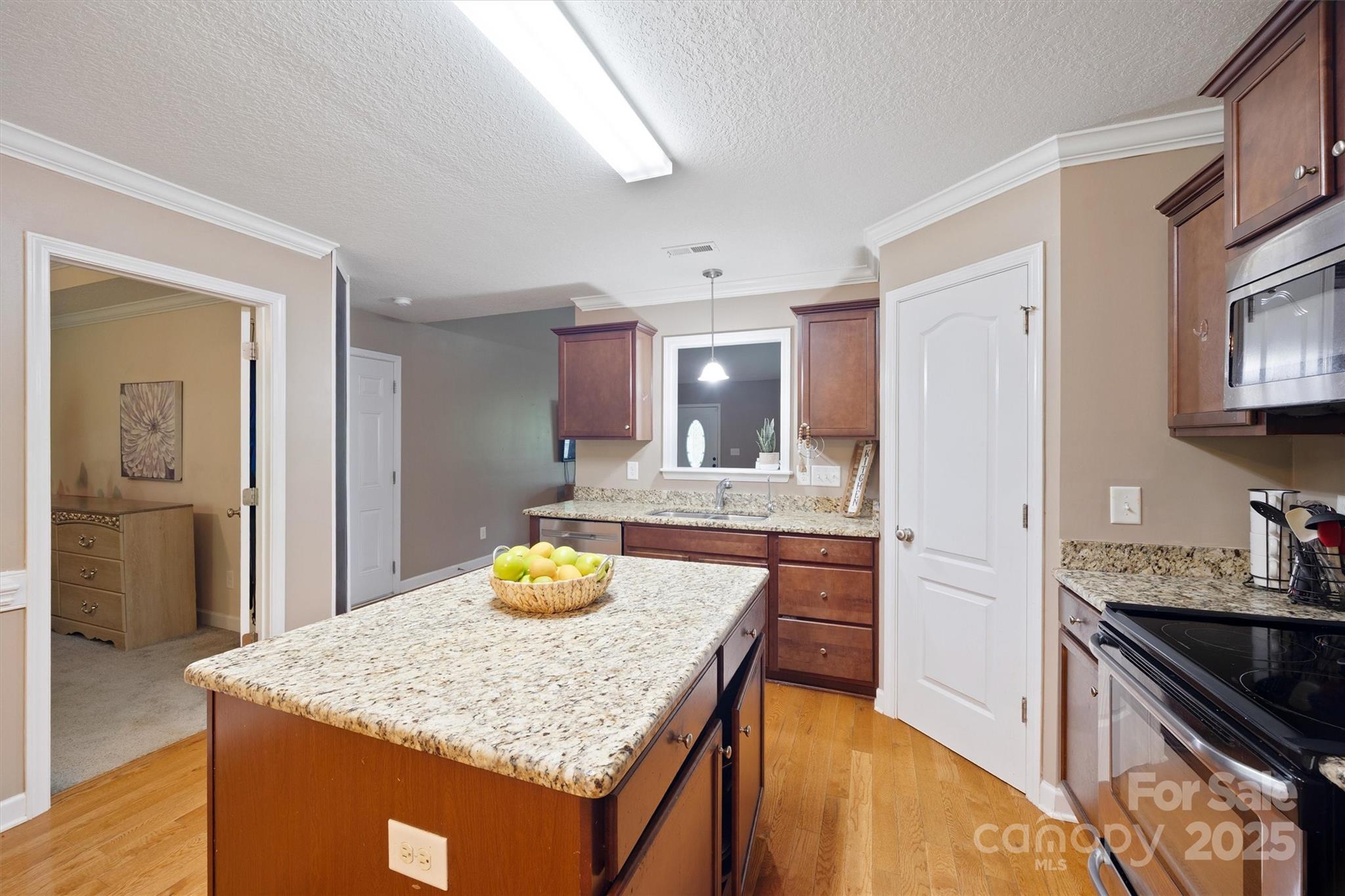 587 Kelly Road York, SC 29745 - Photo 11 of 28 a kitchen with stainless steel appliances granite countertop wooden cabinets and sink