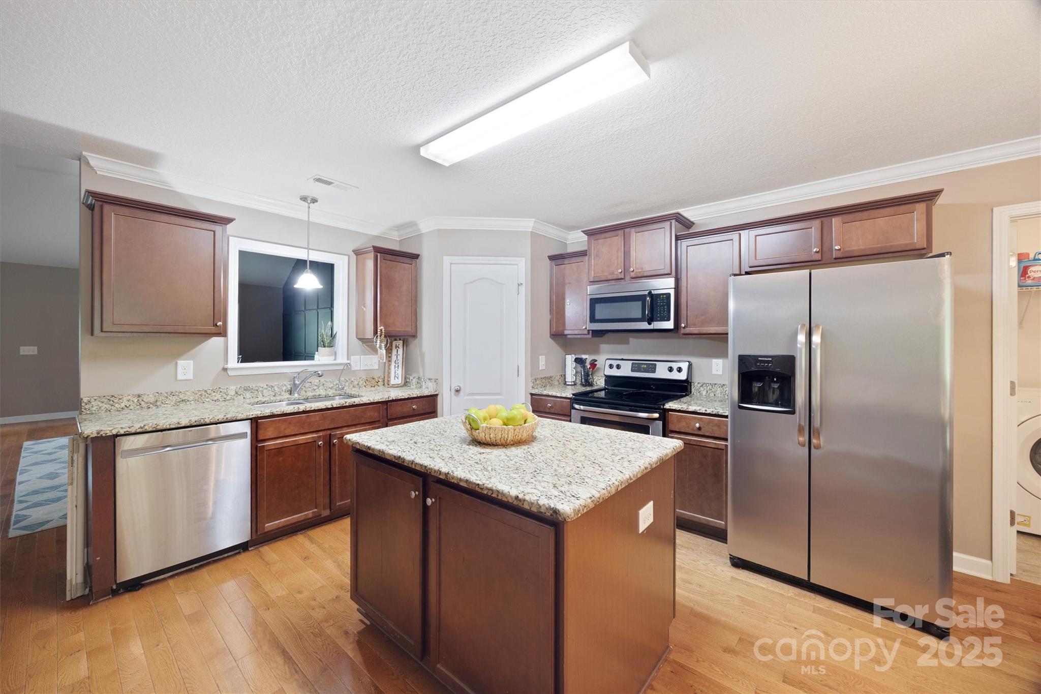 587 Kelly Road York, SC 29745 - Photo 10 of 28 a kitchen with stainless steel appliances granite countertop a sink stove and refrigerator