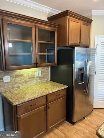 a kitchen with stainless steel appliances granite countertop a refrigerator and a sink