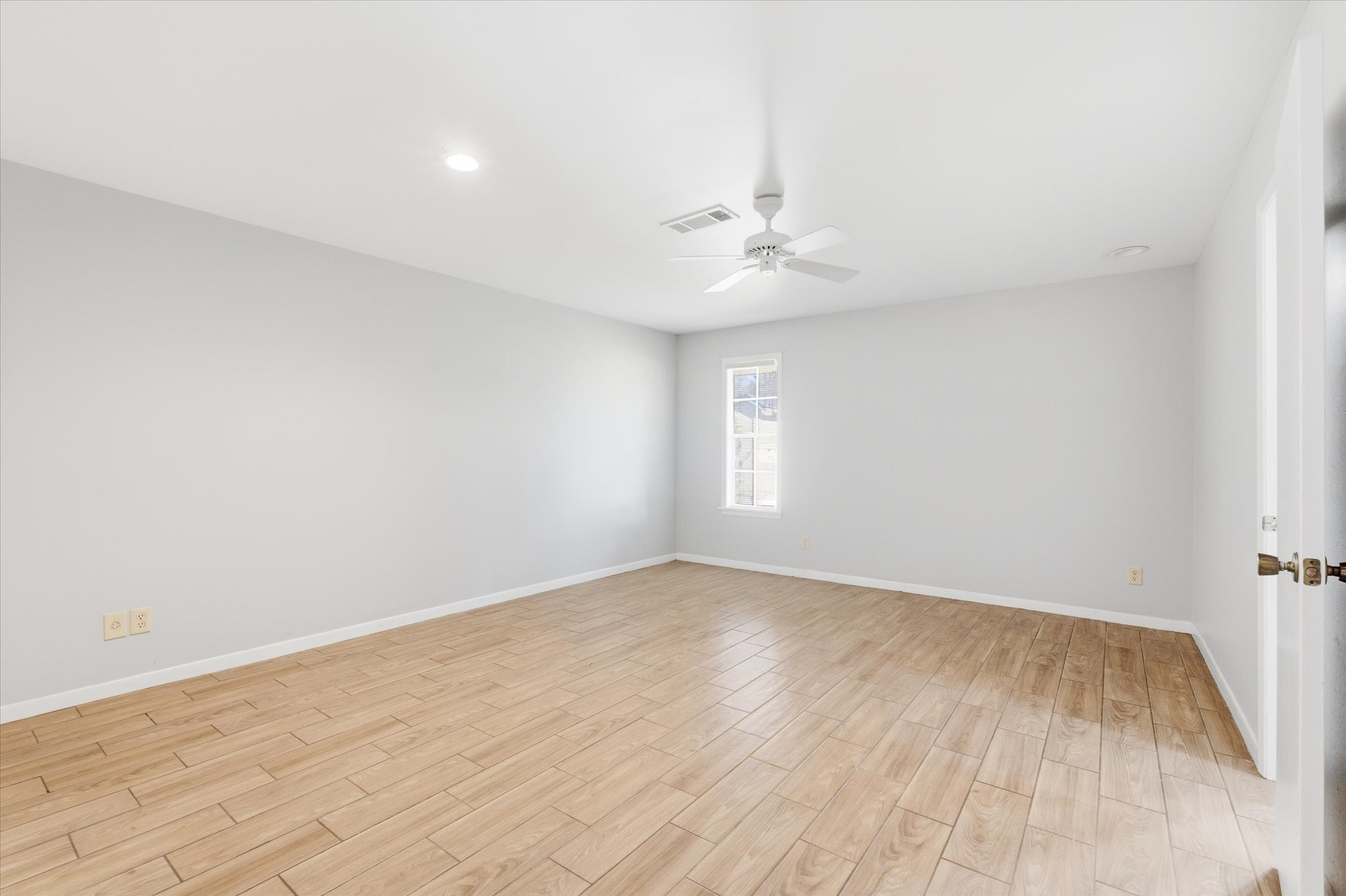 6004 Lakeside Drive Liberty, TX 77575 - Photo 14 of 28 wooden floor in an empty room with a window